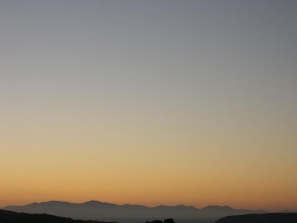 The beauty of the skies as the sun goes down and dusk sets in is captured in this photo. It sets a mellow scene that contrasts to the head and brightness of the afternoon sunshine.